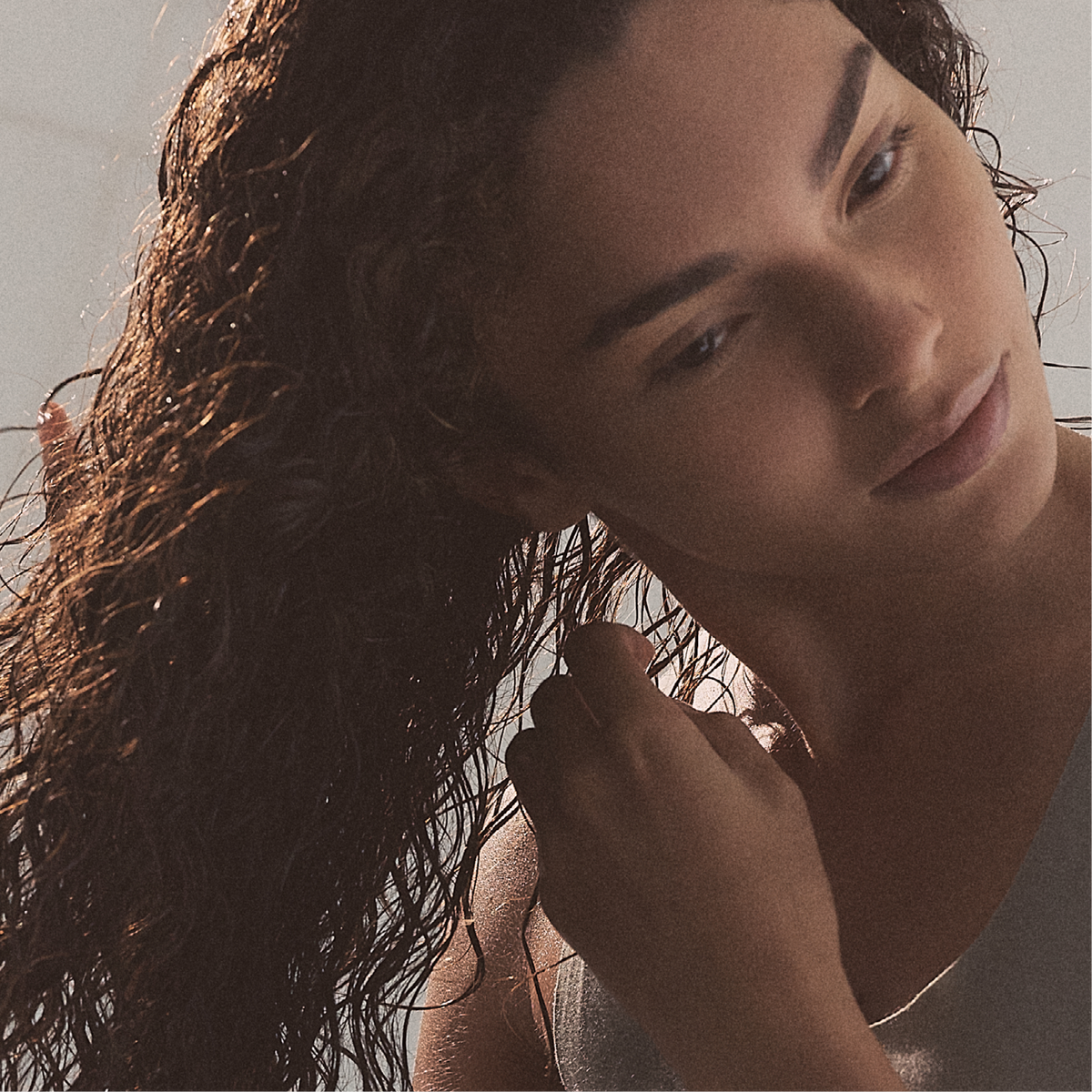 L'ANZA hair styling with wet hair being gently combed through by hand